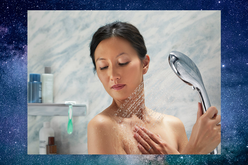 Woman using handshower with galaxy background